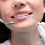 Patient experiencing tooth sensitivity during a dental consultation