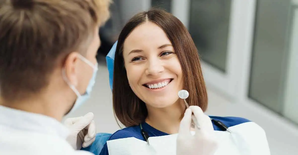 Dentist examining enamel wear and gum recession related to tooth sensitivity