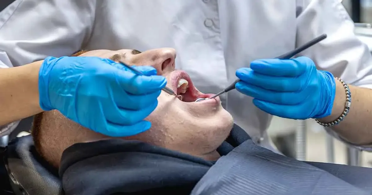 Patient taking first aid steps at home after breaking a tooth