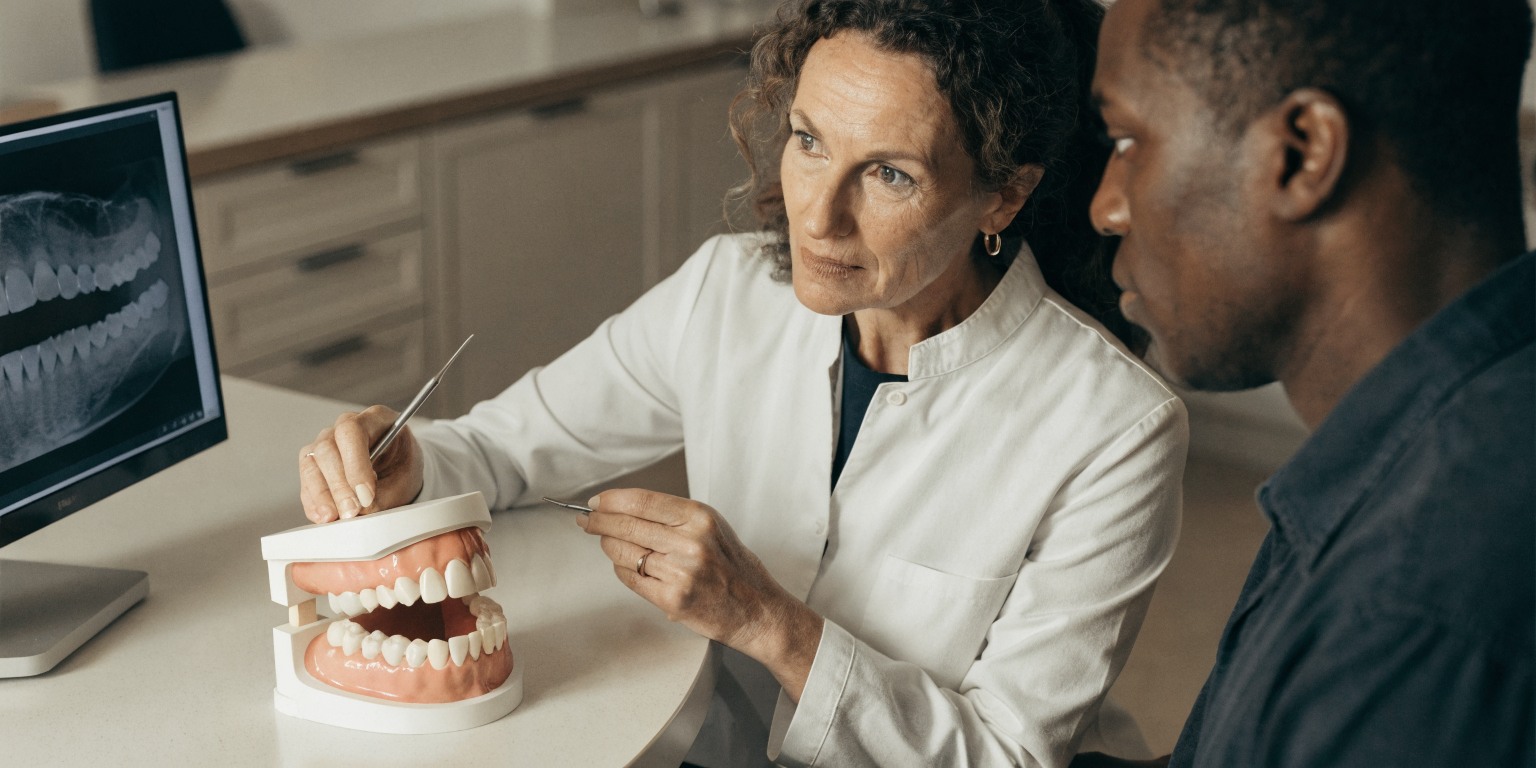 Dental examination identifying factors that may extend a Hollywood Smile treatment trip