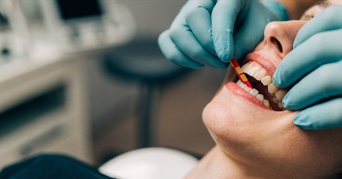Dentist assessing bite and tooth contact before choosing a ceramic veneer or crown