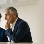 Dentist discussing dental implant planning with an adult patient who has diabetes