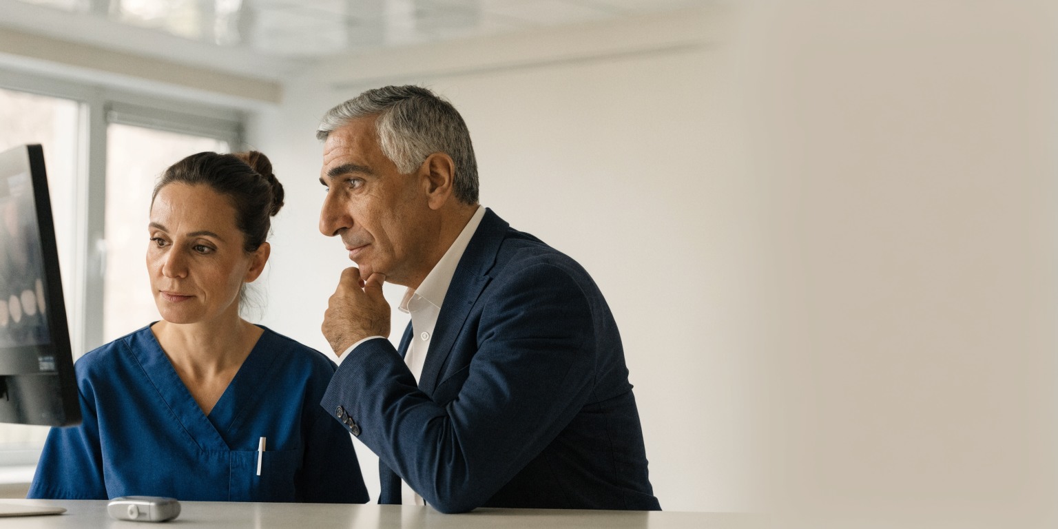 Dentist discussing dental implant planning with an adult patient who has diabetes