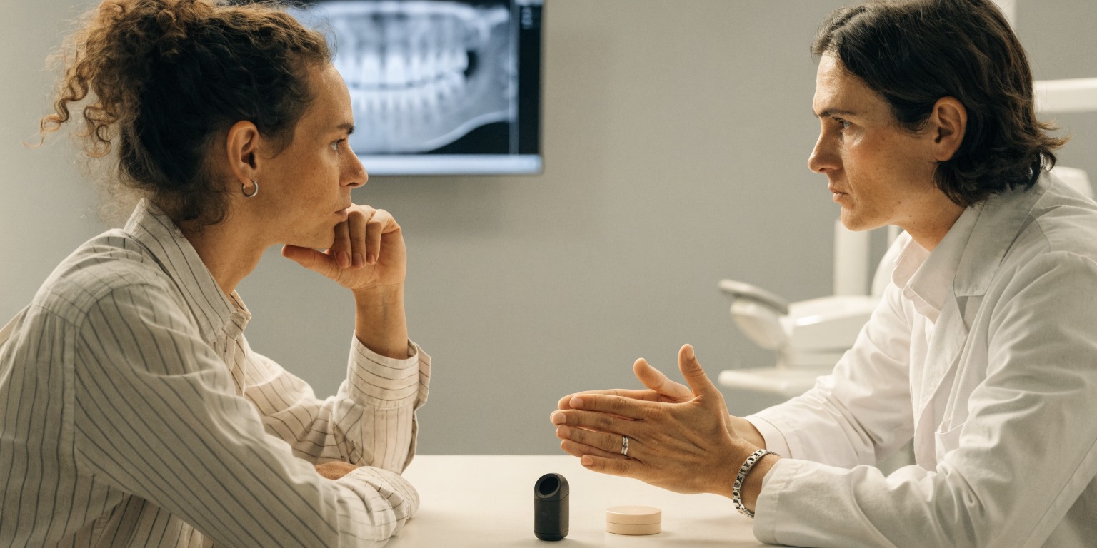 Dentist discussing vaping and nicotine use during dental implant planning
