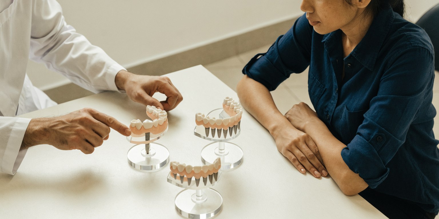 Dentist comparing dental implant treatment options for an upper-jaw case