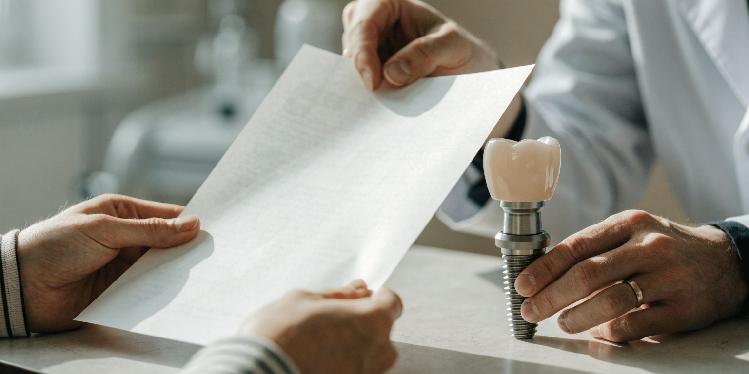 A dentist explains the fixture, abutment, and crown used in a dental implant restoration