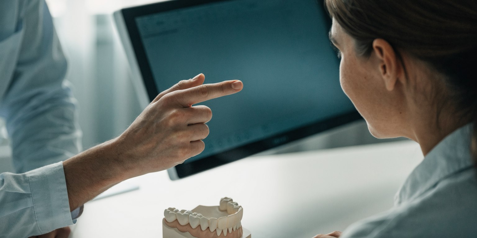 Patient reviewing an individual implant treatment plan with a dentist