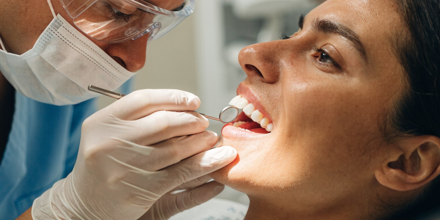 Dental review of gum health and restoration margins during Hollywood Smile maintenance