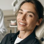 Dentist reviewing long-term Hollywood Smile restorations, gums and bite during follow-up