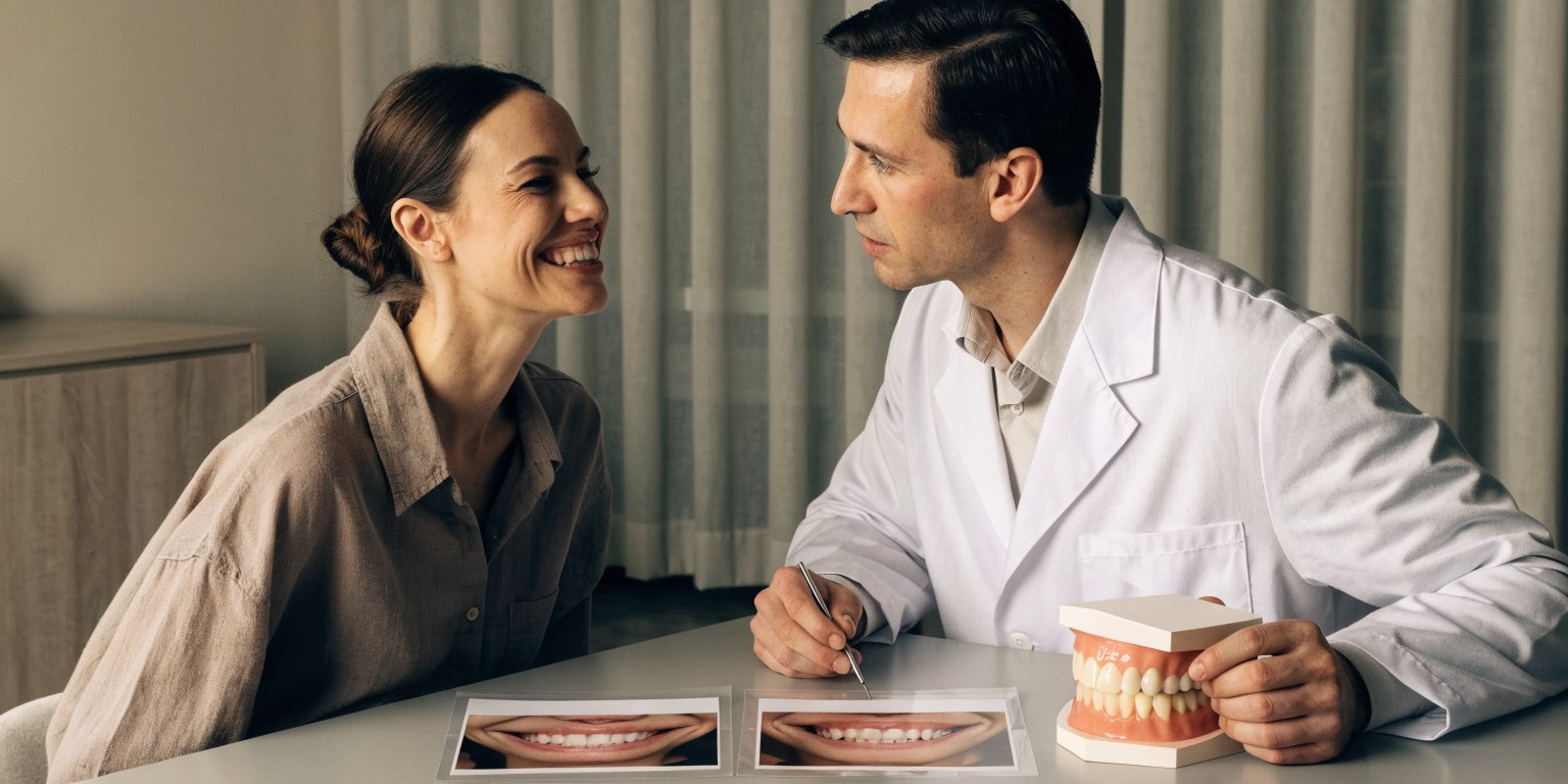 Dentist assessing visible teeth and smile width to plan how many teeth need Hollywood Smile treatment