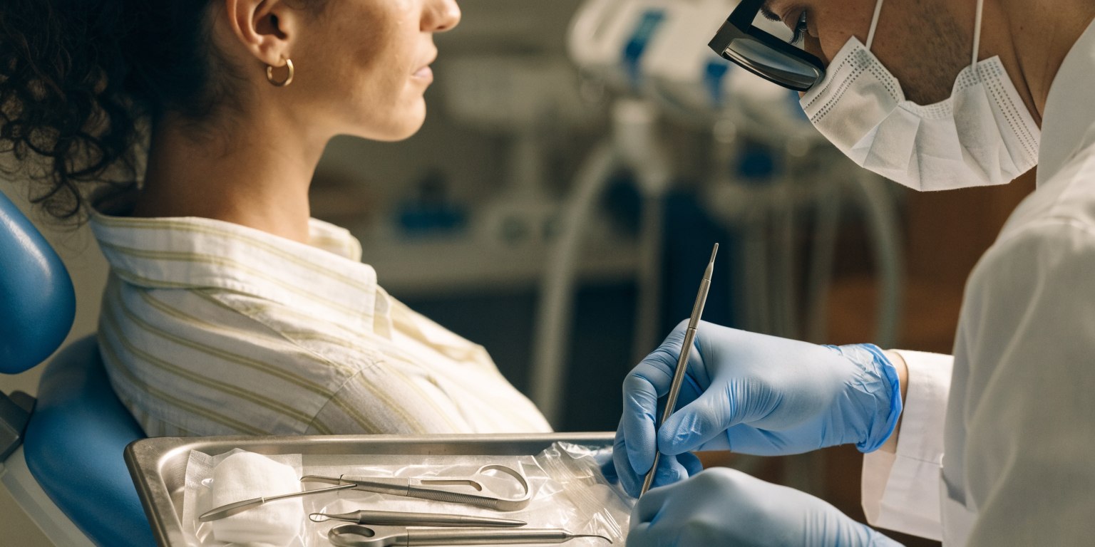 Dentist preparing for a routine follow-up examination with an adult patient