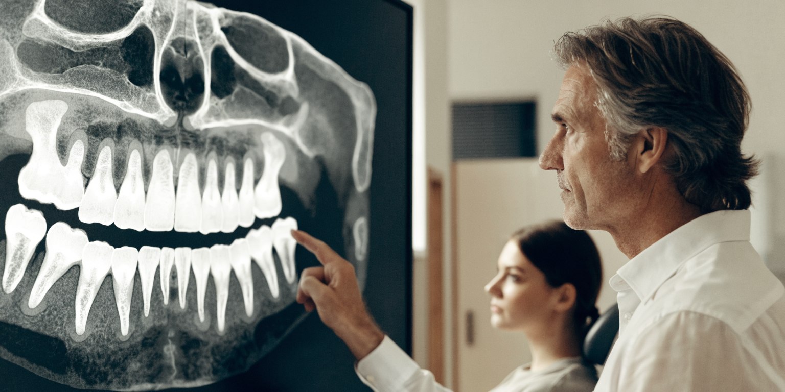 Dentist reviewing upper jaw and maxillary sinus anatomy for implant planning